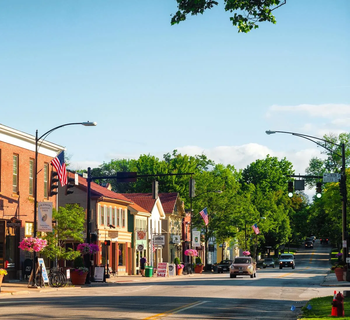 A small-town main street lined with shops and trees on a sunny day